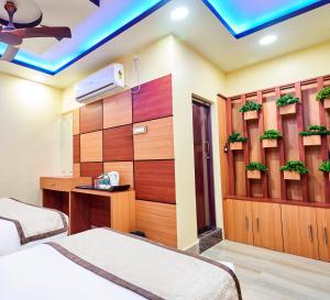 Alīpur DuārHotel Bangabhumi的一间酒店客房,设有两张床和电视