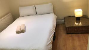 伦敦海德公园客房公寓的一间卧室配有一张床,上面有两条毛巾