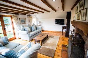 利奇菲尔德Beautiful 3 Bedroom Cottage - Picturesque Retreat的带沙发和壁炉的客厅