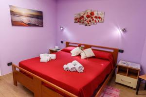 特乌拉达Rio Launaxi Guest House的一间卧室配有红色的床,上面有毛巾动物