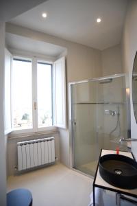 佩鲁贾Suite Calderini的一间带玻璃淋浴和水槽的浴室