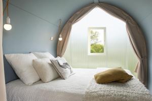 塞夫勒河畔圣洛朗Camping le Rouge Gorge **** 10' Puy du Fou的一间卧室设有一张大床和大窗户