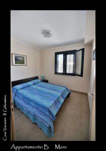 法维尼亚纳伊勒格兰索米诺酒店的一间卧室配有一张带蓝色棉被的床