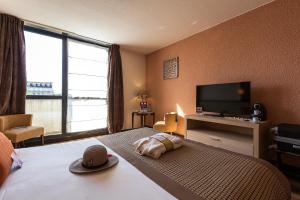 维希维希特玛利亚美居酒店的配有一张床和一台平面电视的酒店客房