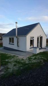 洛赫博伊代尔The Chalet, 444 North Lochboisdale的黑色屋顶的白色房子