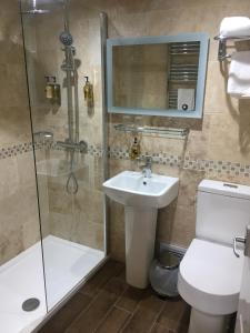 威灵堡雌鹿酒店的浴室配有卫生间、盥洗盆和淋浴。