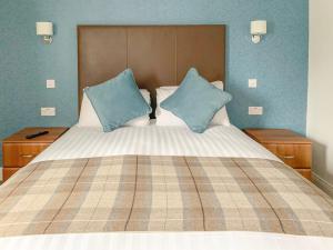 斯特灵罗伯特国王酒店的床上有2个蓝色枕头
