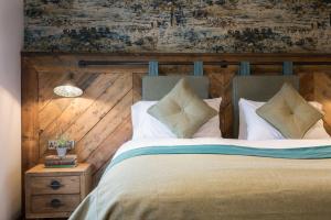 牛顿阿伯特Dartmoor Halfway Inn的一间卧室设有一张带木墙的大床