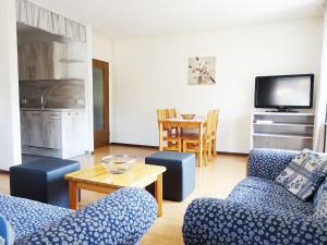 博伦多夫Spacious Apartment in Bollendorf in Nature Park with Sauna的客厅配有2把蓝色椅子和桌子