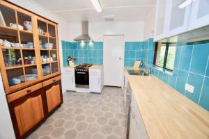 黑荒地Waragil Cottage - Original Settler's Home的厨房设有蓝色瓷砖墙壁和台面