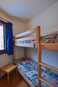 雷莱克斯VVF Les Monts Jura的一间卧室设有两张双层床和一张桌子