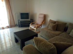 弗洛伊塔Labrini's House的客厅配有沙发、椅子和电视