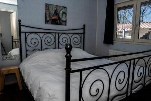 圣安娜兰Chaletparc Krabbenkreek Zeeland - Chalet 50的卧室设有黑白床和窗户。