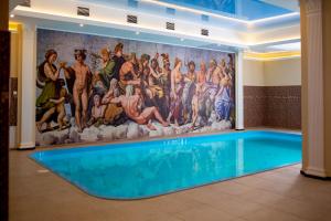 乌曼岛Hotel Complex Olimp的带有游泳池的酒店客房内的壁画