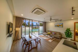 会安Beach Haven Suites Hội An Apartment的客厅配有桌子和沙发