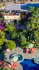 托多斯桑托斯Los Colibris Casitas的享有游泳池的空中景致,配有椅子和遮阳伞