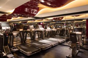 巴黎La Réserve Paris Hotel & Spa的健身房设有一排椅子和镜子