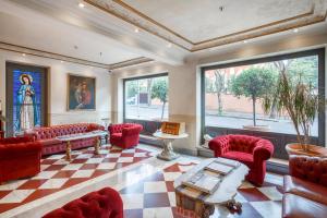 罗马圣皮欧别墅酒店的客厅设有红色椅子和 ⁇ 格地板