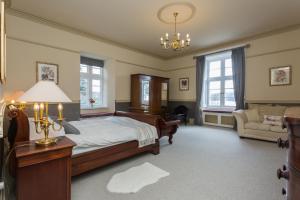 安布尔塞德The Lake House, Wansfell Holme, Windermere的一间卧室配有一张床、一张桌子和一张沙发