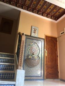 马拉喀什Flashback House的一间设有楼梯的房间和一扇带马赛克墙的门