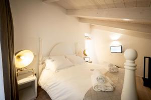 阿尔塔穆拉La casa del calzolaio的卧室配有白色床和毛巾