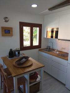 奥亚A Guaira, fantástico apartamento al borde del mar的厨房配有木桌和水槽。