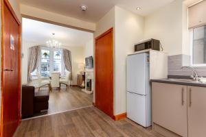 布莱克浦Beachcliffe Lodge Apartments的带冰箱的厨房和用餐室