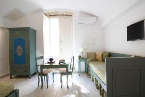 加利波利Duomo Gallipoli B&B and Apartments的一间带床和桌子的客厅以及一间用餐室