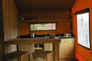 古奥巴蒂达特Càmping Parc Gualba的厨房配有带凳子和水槽的台面