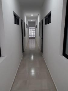 坎昆Estudio en Cancún centro的长长的走廊,有白色的墙壁和窗户