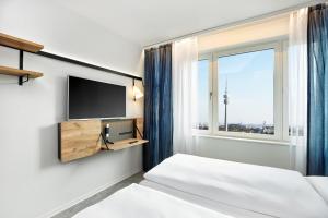 H2 Hotel München Olympiapark客房内的一张或多张床位