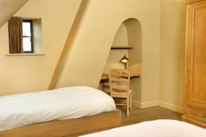 达默De Grote Wateringe的客房设有一张床和一张带梯子的书桌