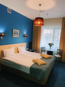 莫斯科安提克酒店的一间卧室设有一张蓝色墙壁的大床