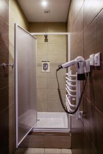 罗兹精品旅馆 的浴室设有淋浴,墙上配有电话