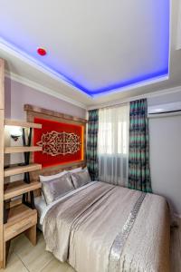 安塔利亚Linda Expo Palace的一间卧室配有一张大床和红色床头板