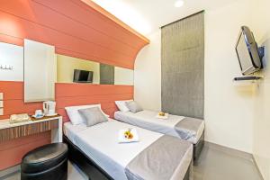 新加坡新加坡81酒店 - 梧槽的酒店客房设有两张床和电视。