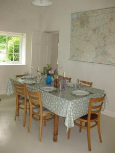 沃明斯特Job's Mill Cottage的一间带桌椅和地图的用餐室