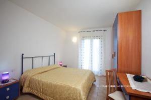Residence Ai Campi Da Golf Saturnia客房内的一张或多张床位