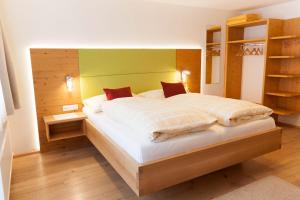 费尔兹姆斯B&B Landhaus Vierthaler的一间卧室配有一张大床和木制床头板