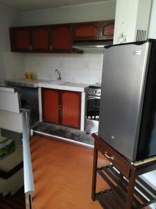 利马Mini Departamento Tambo Huascar 2的厨房配有水槽和冰箱