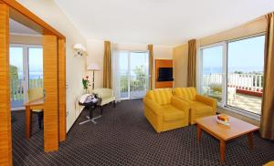 伊佐拉Hotel Mirta - San Simon Resort的客厅配有黄色椅子和沙发
