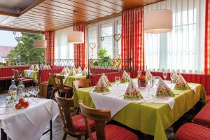 布劳博伊伦Gasthof - Hotel zum Ochsen GmbH的用餐室设有桌椅和窗户。