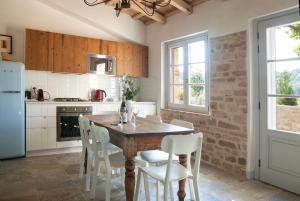 SantʼElpidio MoricoCasale Biancopecora的厨房配有木桌和白色椅子