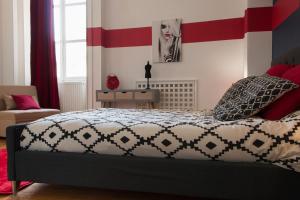 布尔日la Casa D'estève的一间卧室配有一张红色和白色条纹的床