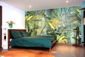 阿姆斯特丹Private Studio - FREE PARKING的卧室的墙上装饰有热带壁画