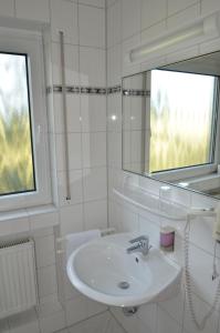美因河畔法兰克福舒尔巴赫霍夫兰德酒店的白色的浴室设有水槽和镜子