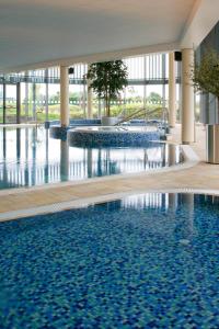 阿什本Pillo Hotel & Leisure Club的蓝色建筑中的游泳池