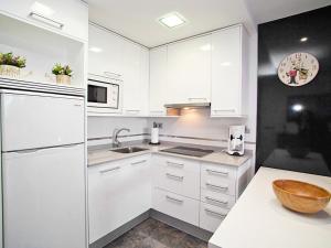 维拉福林Apartment DMS V by Interhome的白色的厨房配有白色橱柜和水槽