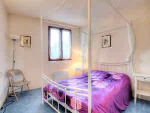 卡布勒通曼塔GP106公寓的一间卧室配有一张带紫色棉被的天蓬床