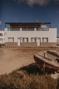 塞博河畔卡莱塔La Pardela Excellence Apartamentos的坐在建筑物前的船